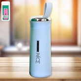 Light blue glass vacuum flask with a shiny silver lid, green button, and a pale blue carrying loop.