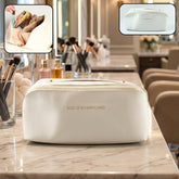 Waterproof travel makeup organizer pouch with handle closed, showing sleek design