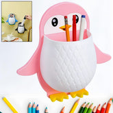 Pink penguin wall organizer holding three colorful pens and pencils, with a small inset showing blue and black versions in