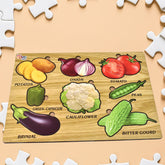 A light brown wooden puzzle board with nine colorful vegetable pieces, including potatoes, onion, tomato, capsicum,