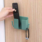Compact wallmount mobile stand with integrated hook, holding a smartphone and keys.