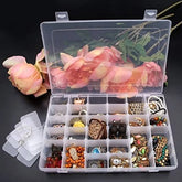 Transparent plastic organizer box with 36 grids filled with various colorful jewelry, next to pink roses.