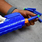 Child playing with a foam bullet gun, aiming at a target
