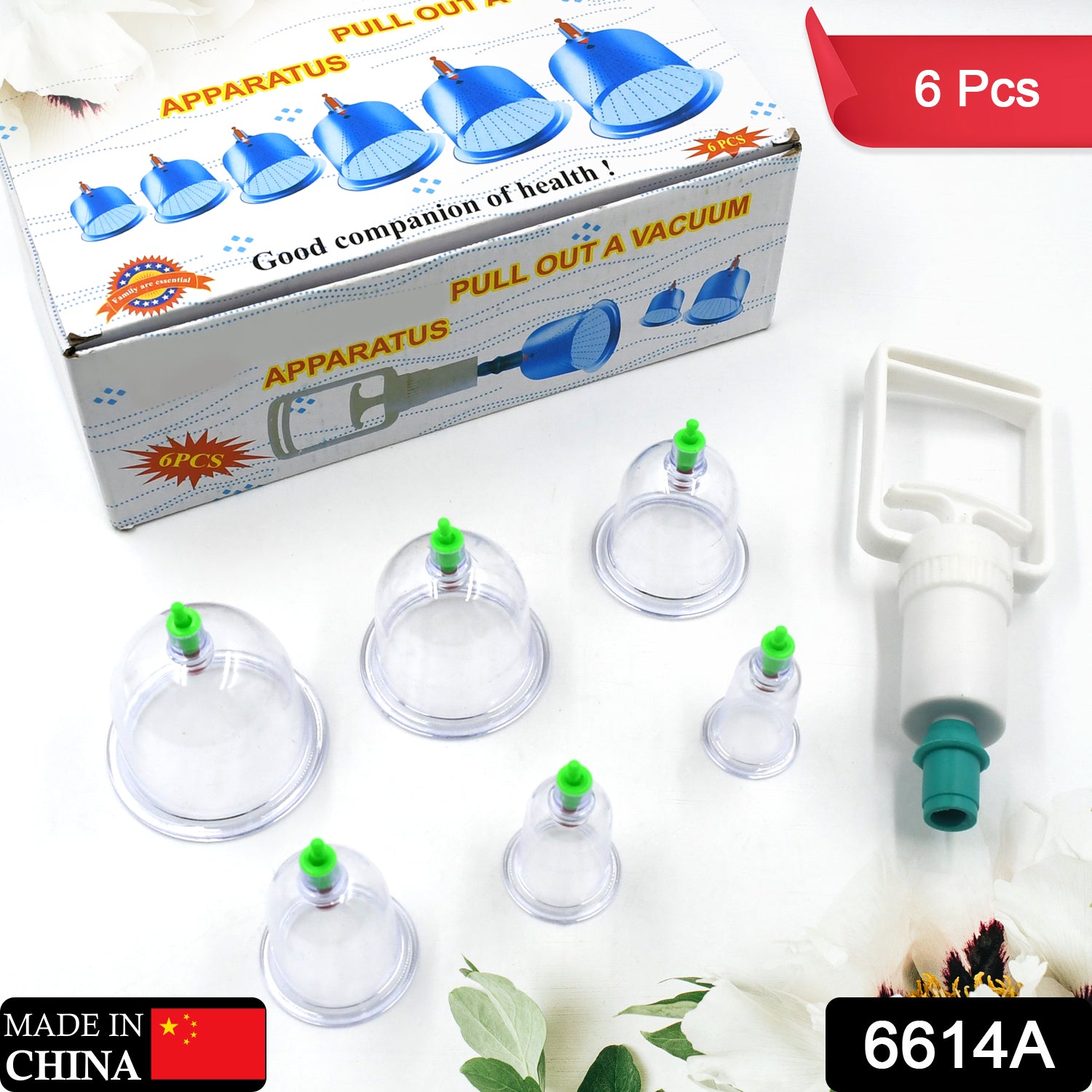 A vacuum cupping set with a white box, six clear cups with green tops, and a white pump with a green tip.