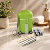 A green mini suitcase-shaped grooming kit with various metal tools, including scissors and clippers, displayed on a bathroom