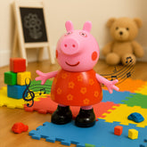 Pink Peppa Pig toy with a red floral dress and black shoes, standing on a colorful playmat with building blocks and a teddy