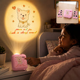 A child smiles at a wall projection of a cartoon dog and text from a pink projector on a nightstand.