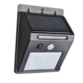A black solar motion sensor light with a grid of twenty white LEDs and a small solar panel on top.