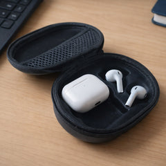 An open black oval case revealing white wireless earbuds and their charging case inside a molded compartment.