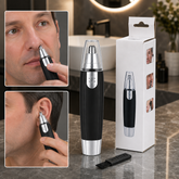 A man uses a black and silver nose and ear hair trimmer, with the product and its box in the background.