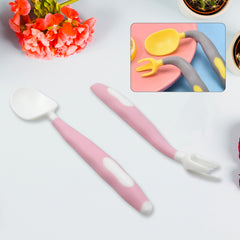 A pink and white baby spoon and fork with bendable handles, displayed on a white surface with flowers.