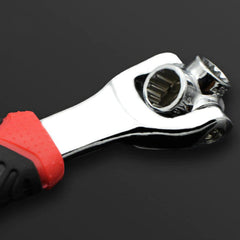A detailed view of the chrome wrench head showing two different socket sizes and part of the red and black handle.