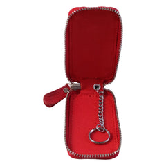 A vivid red leather key holder, partially unzipped, displays its silver chain and key ring against a white background.