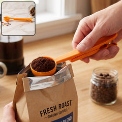 An orange plastic scoop with coffee grounds is held over a bag, with a small inset showing it clipping a bag of spices.