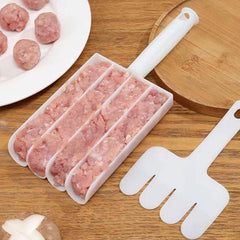 A white plastic multi-chambered sausage maker filled with ground meat sits on a wooden board.