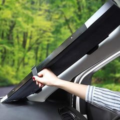 A blue box with product details stands next to a black and silver retractable car sunshade on a white background.