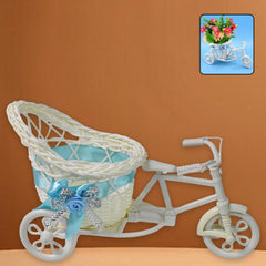 Side view of a white decorative bicycle with a woven basket adorned by a blue bow and sparkly details.