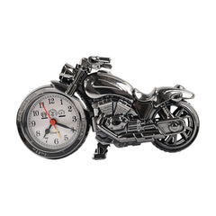 A detailed silver motorcycle clock with a white face and black numbers is presented on a plain white background.