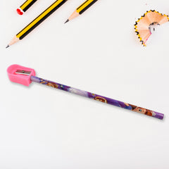 A pink pencil sharpener is actively sharpening a purple Sofia the First pencil, with wood shavings visible.