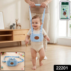 A baby in a light blue walking harness with a brown emblem on the chest, held by an adult. A product box and a close-up of