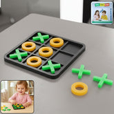Black tic tac toe board with green X's and yellow O's, with extra pieces beside it.