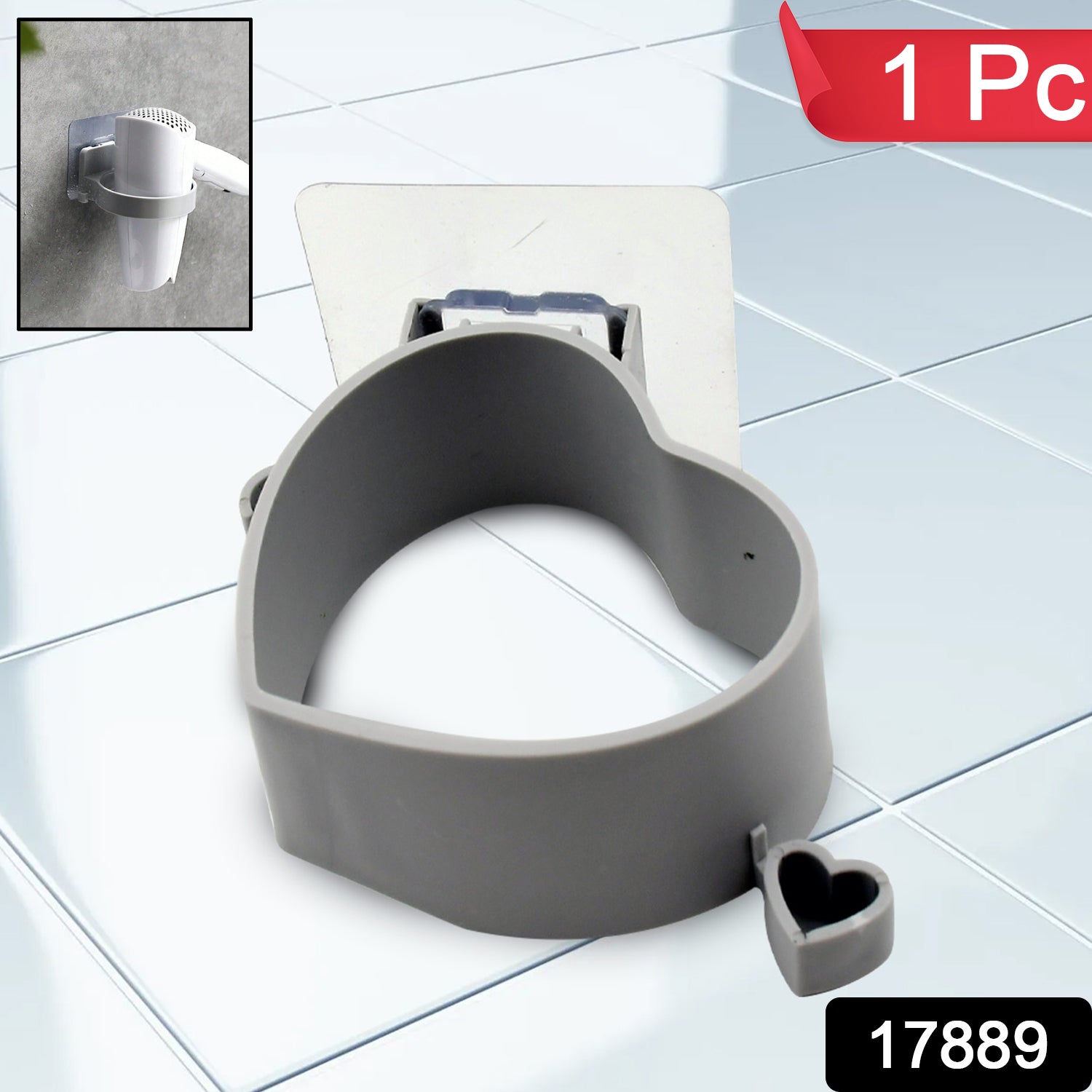 A gray heart-shaped hair dryer holder with a small heart charm, attached to a white wall mount on a tiled surface.