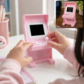 A person's hands are playing a pink mini arcade console with a blank screen, while an inset shows a game running.