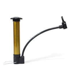 The gold and black hand pump is positioned in a workshop setting, highlighting its metallic finish and sturdy base.