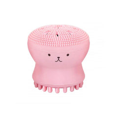 A single pink octopus-shaped silicone facial cleansing brush with a textured top and bottom stands upright.