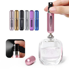 A hand holds a pink atomizer above a large perfume bottle, with other colored atomizers in the background.