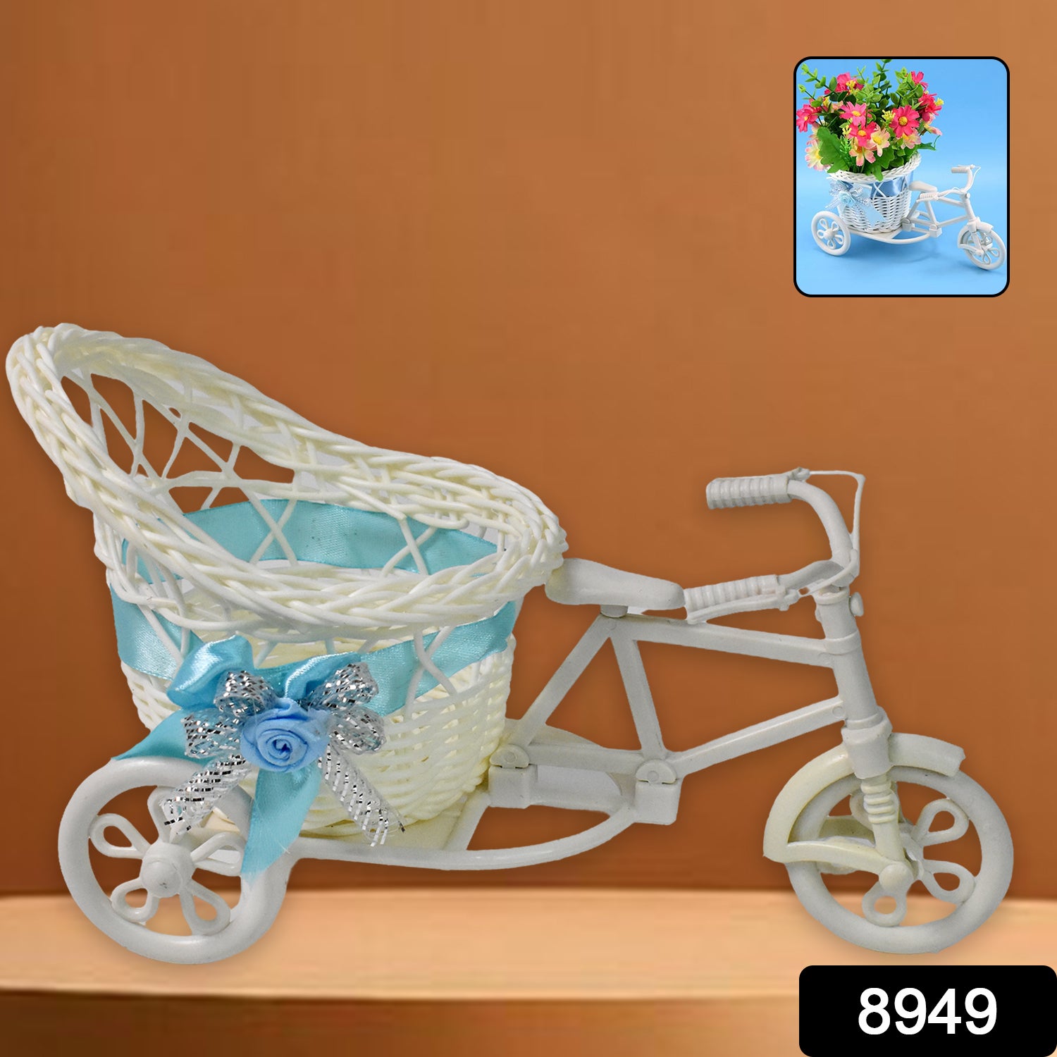 White plastic bicycle-shaped planter with a woven basket holding a light blue ribbon and silver accents.