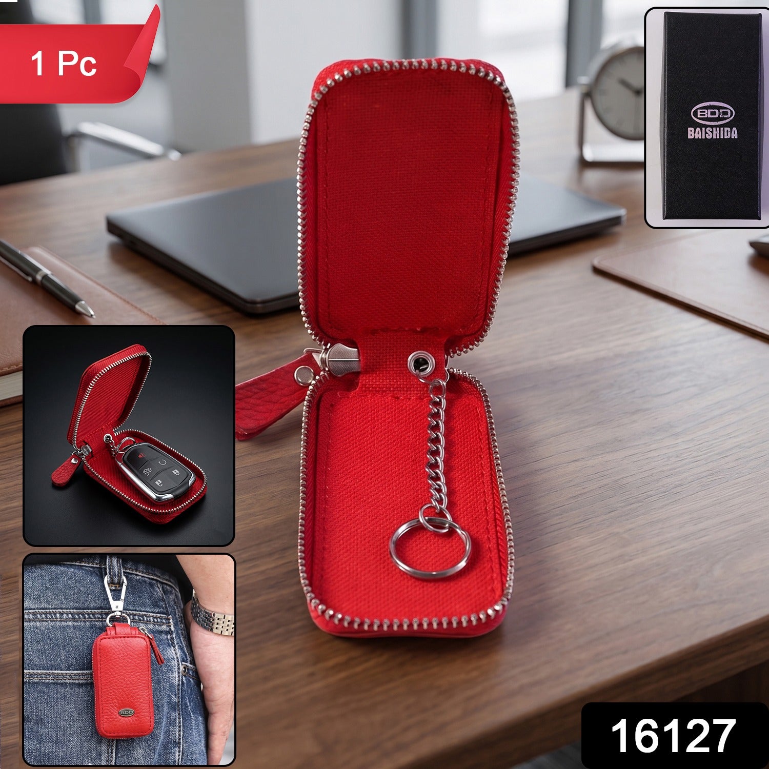 An open red leather key pouch with a silver chain and ring, displayed on a wooden desk with insets showing a key inside and