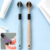 Two three-sided toothbrushes, one blue and one beige, with white toothpaste and dental floss in the background.