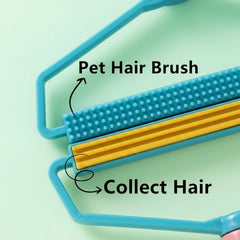 The pink and blue lint remover rests on a white textured fabric, showing its full design from above.