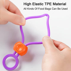 Two hands stretch a purple silicone bag clip, demonstrating its high elasticity and flexible TPE material.