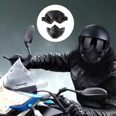 A person on a motorcycle wearing the black helmet, goggles, and face mask, with an inset showing the mask separated.