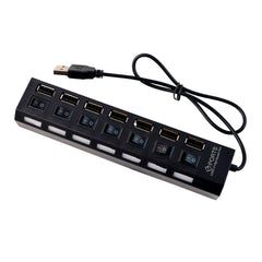 A black 7-port USB hub with individual switches and a coiled cable is displayed on a white background.