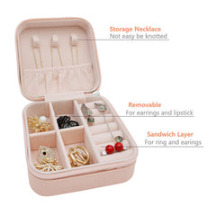 Open pink jewelry box with labels pointing to necklace, earring, and ring storage sections.