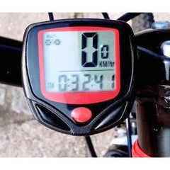 The black and red bicycle computer is mounted on a handlebar, displaying time and speed data.