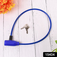 A blue plastic-coated steel cable lock with two silver metal keys on a white wooden surface.
