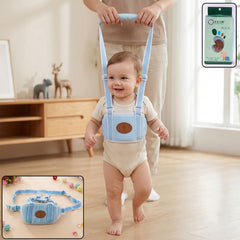 A light blue baby walking harness with a brown emblem on the chest, lying on a gray textured surface with wooden and woven
