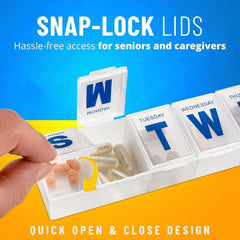 A close-up of a hand opening a clear plastic pill organizer with snap-lock lids, revealing capsules inside.
