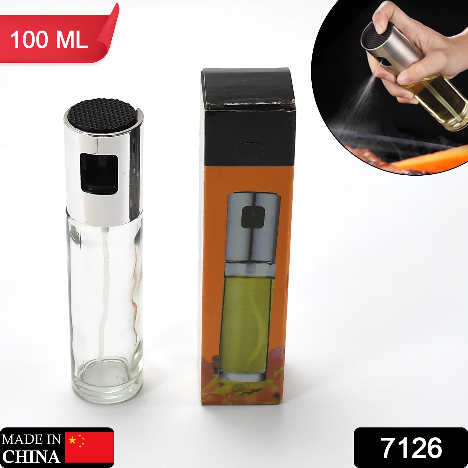 A clear glass and silver oil sprayer next to its orange and black packaging, with a small inset of it spraying.