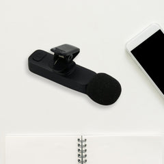 Wireless lapel microphone shown with its charging port and universal compatibility.