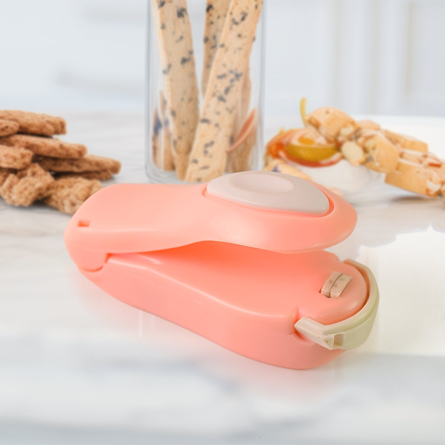 Portable mini heat bag sealer conveniently attached to a refrigerator with its magnetic back.