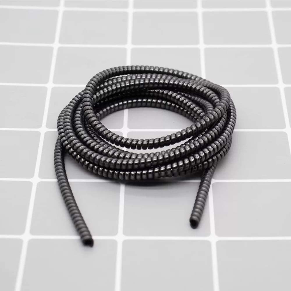Metallic spiral cable protector guarding a smartphone charging cable.