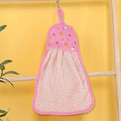 A pink microfiber hand towel with a fruit print top and hanging loop hangs from a hook against a bright yellow wall.