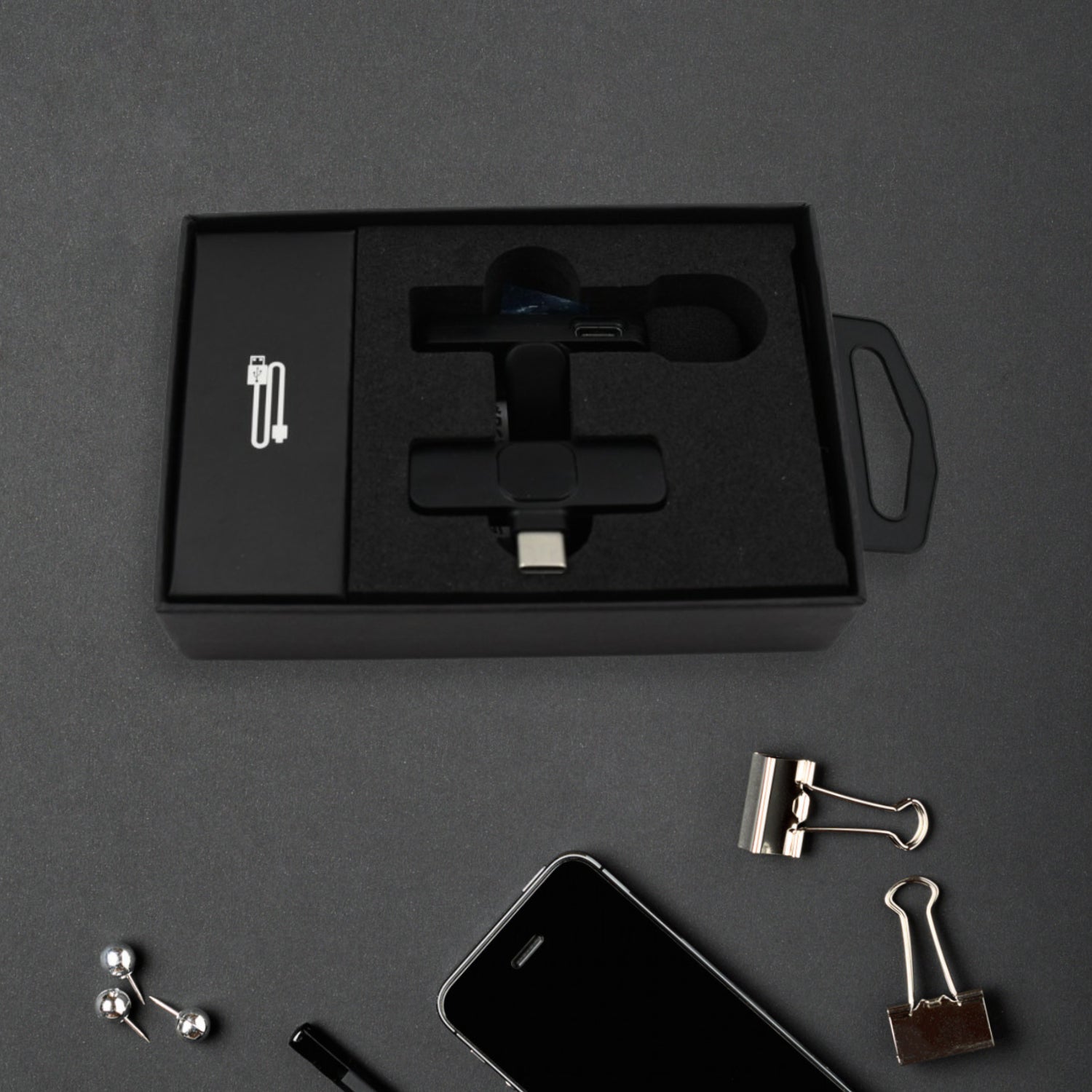 Detailed view of the mini wireless microphone's compact design and features.