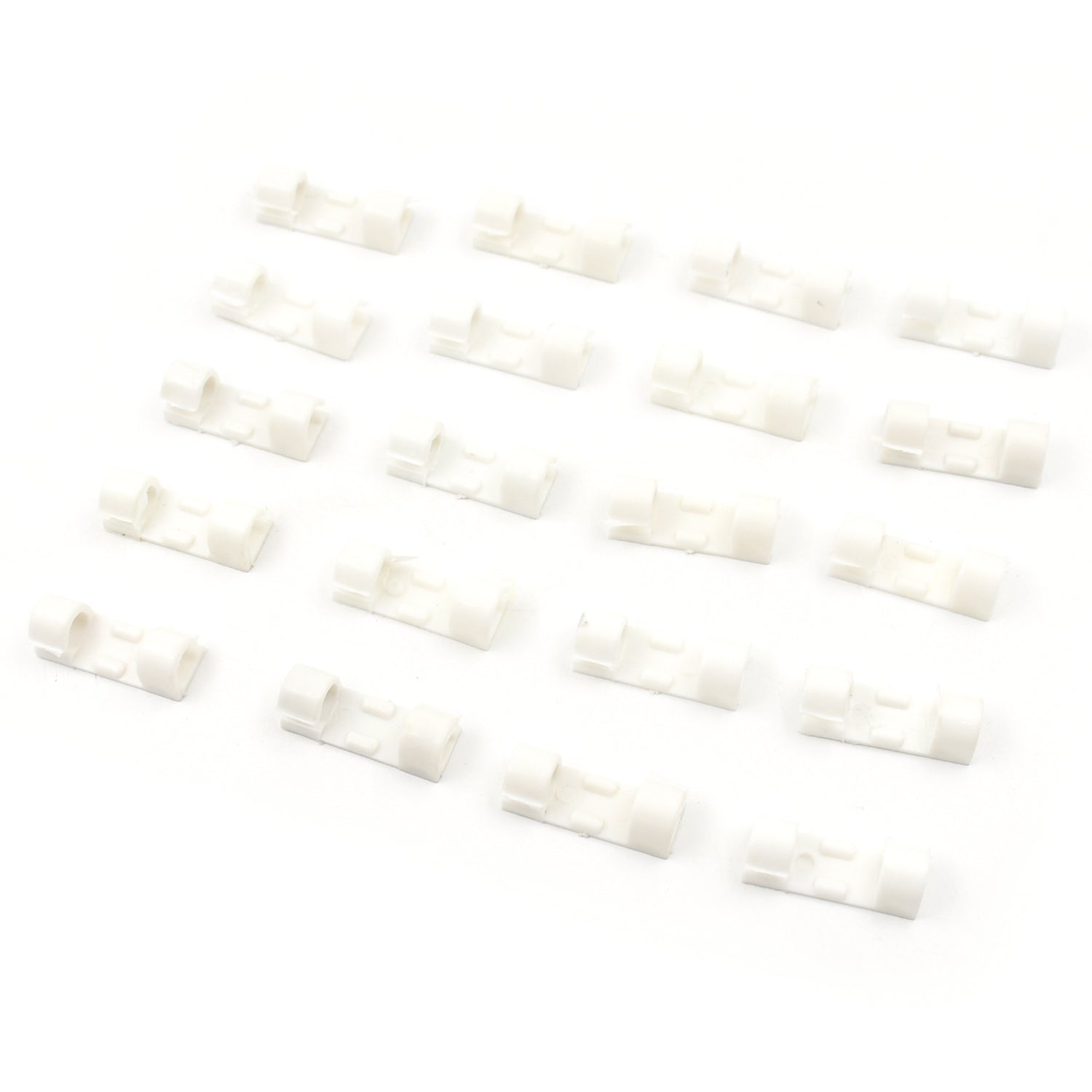 Twenty white plastic cable clips arranged in four rows of five on a clean white background.