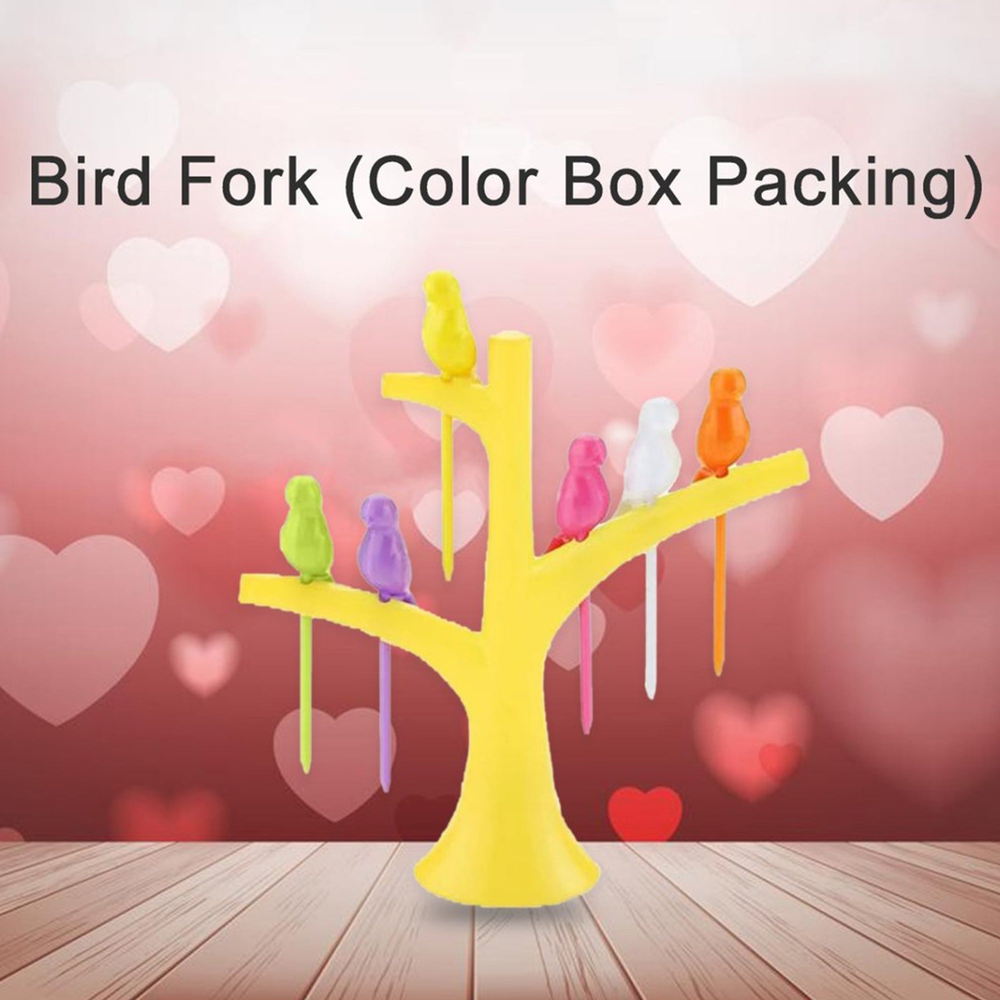 A yellow tree holder with colorful bird fruit forks on a wooden surface with a pink heart-patterned background.